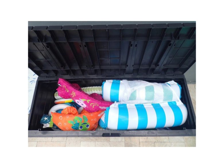 Outdoor deck box with pool toys, beach toys and floaties for little ones.