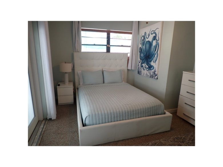 Guest bedroom with queen bed and access to the pool