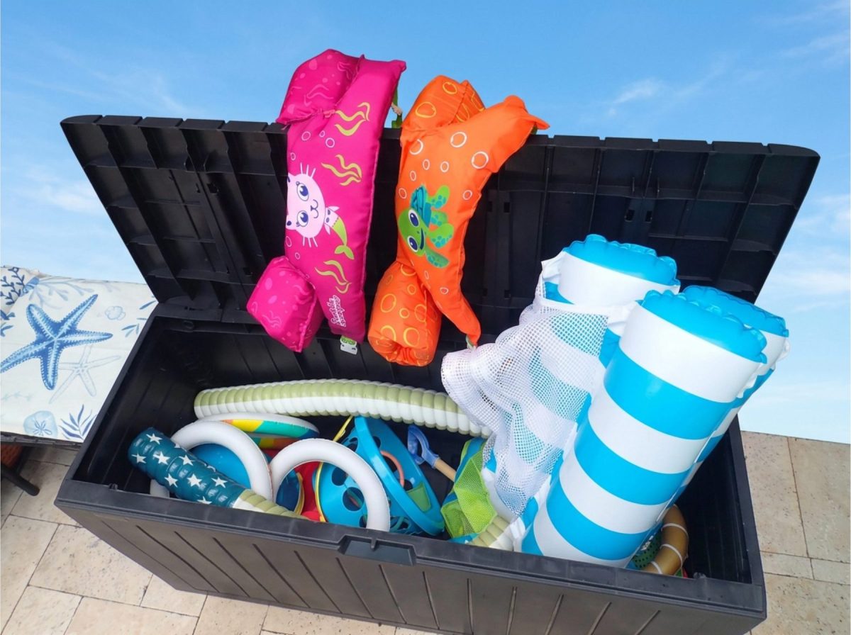 Deck box with beach towels, umbrella and pool toys