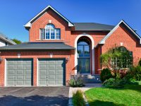 Brick house in suburbs with two car garage